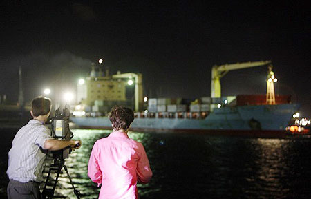 A television crew film the Maersk Alabama docking at the port of Mombasa April 11, 2009.